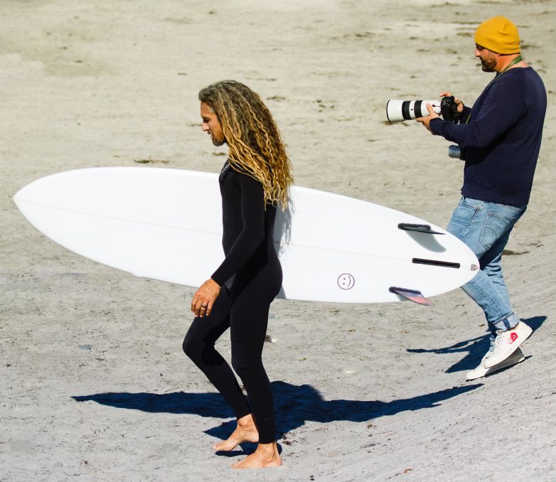 Mark Tesi shooting photos of surfer on beach