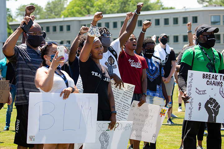 student holding sign at march