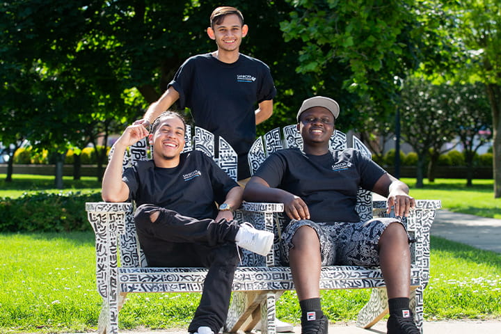 Three students smiling