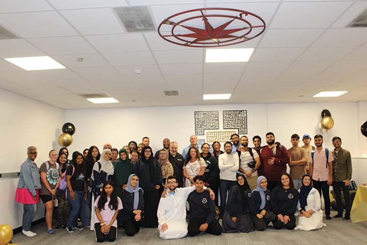 A large group of faculty, staff and students in the new Meditation Room