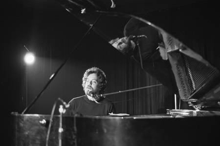 black and white photo of Billy Joel playing piano