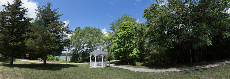 View of Lake Fred, the lit path, and mill site (in woods to the right of the kiosk).