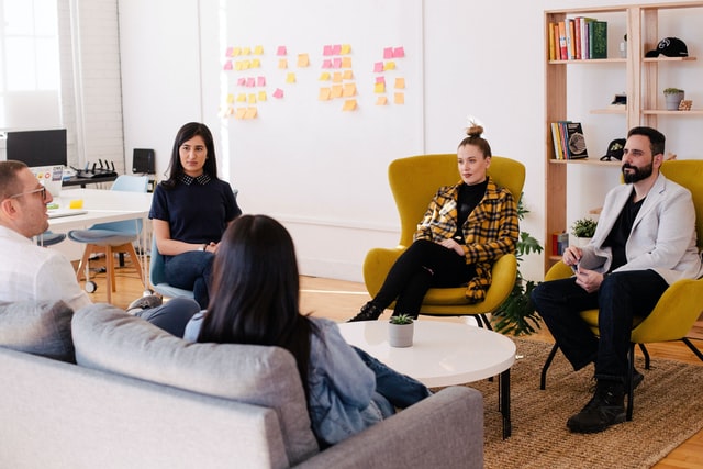 people sitting around a table in a room