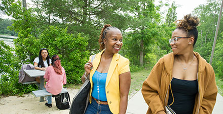 Students walking the path along Lake Fred